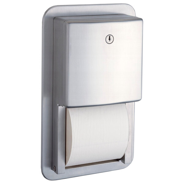 A stainless steel Bobrick toilet paper dispenser with a roll of toilet paper inside.