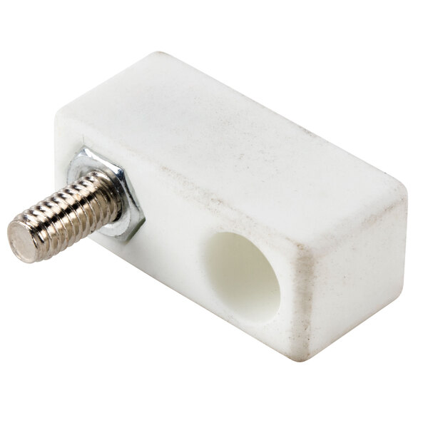 A white plastic block with a screw.