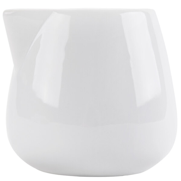 A white ceramic pitcher with a curved top.
