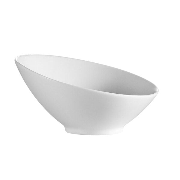 A CAC bone white porcelain salad bowl with a curved edge.
