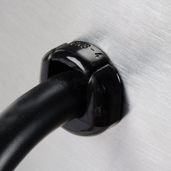 A black cable plugged into a metal surface with a black clamp on the end.
