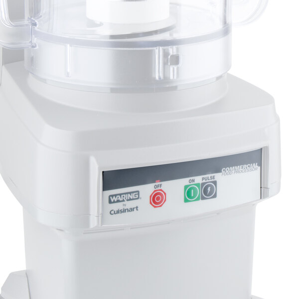 A white Waring food processor with buttons and a clear cover.