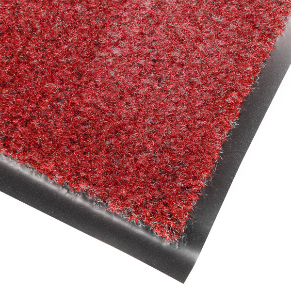 A red entrance mat with black edges.