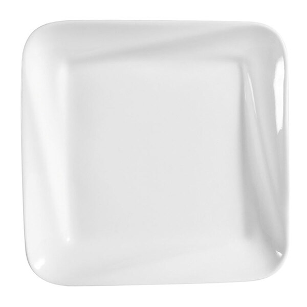 A bright white square porcelain plate with a wavy edge.