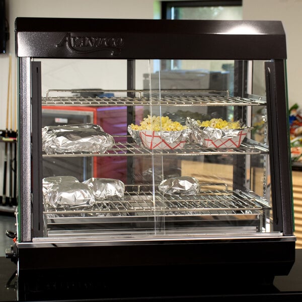 An Avantco countertop heated display case with food inside.