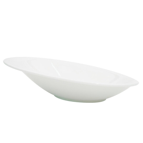 A CAC Collection bone white porcelain oval bowl with a curved edge.