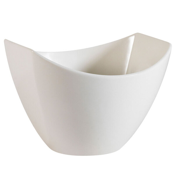 A CAC Studio white porcelain salad bowl with a curved edge.
