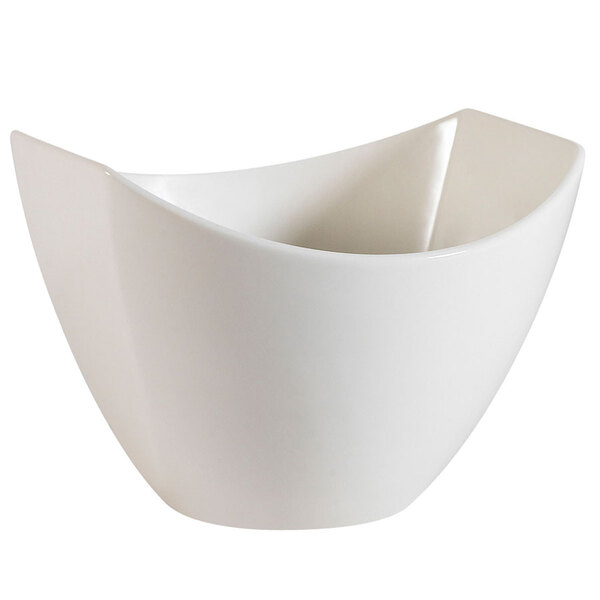 A CAC Studio bone white porcelain salad bowl with a curved edge.