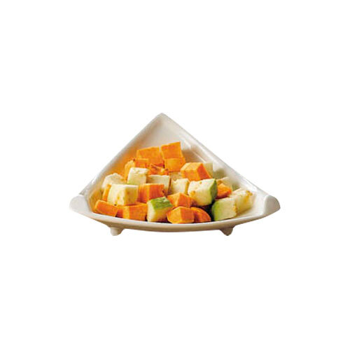 A CAC white triangle plate filled with sliced fruit on a counter.