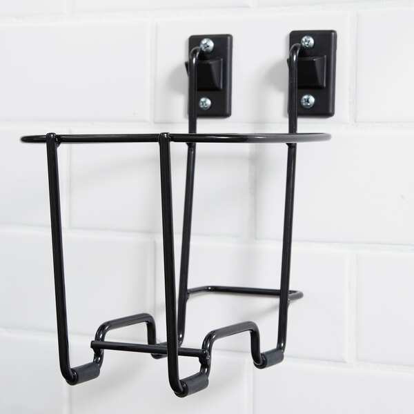 A black metal wire wall mount with two hooks.