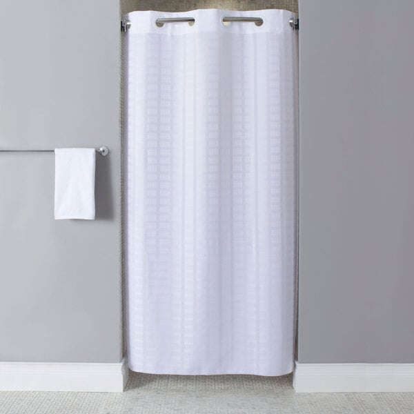 A white Hookless shower curtain in a bathroom.