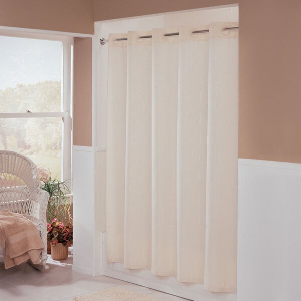 A beige Hookless shower curtain with a white Moire pattern.