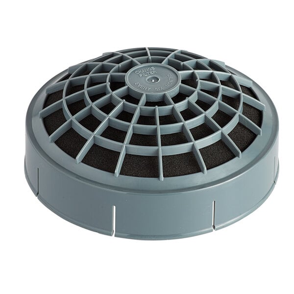 A grey round air filter with a black grid on it.