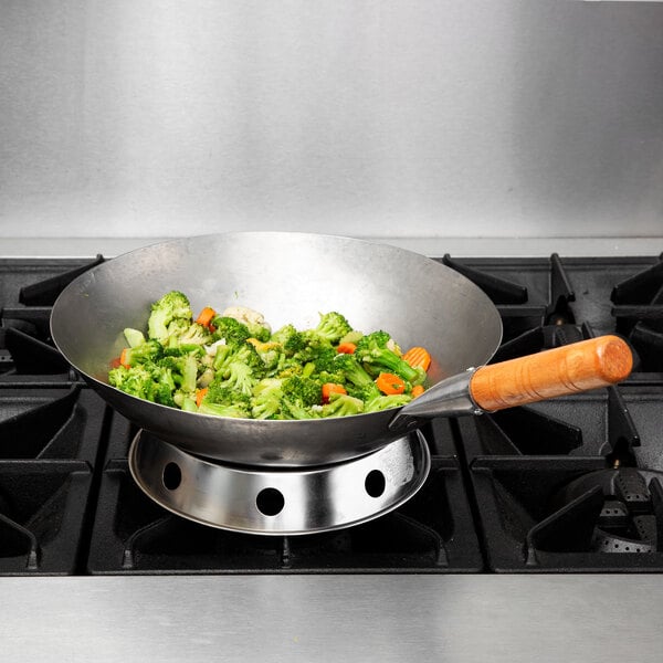 A Town 14" Mandarin Carbon Steel Wok with vegetables in it on a stove.