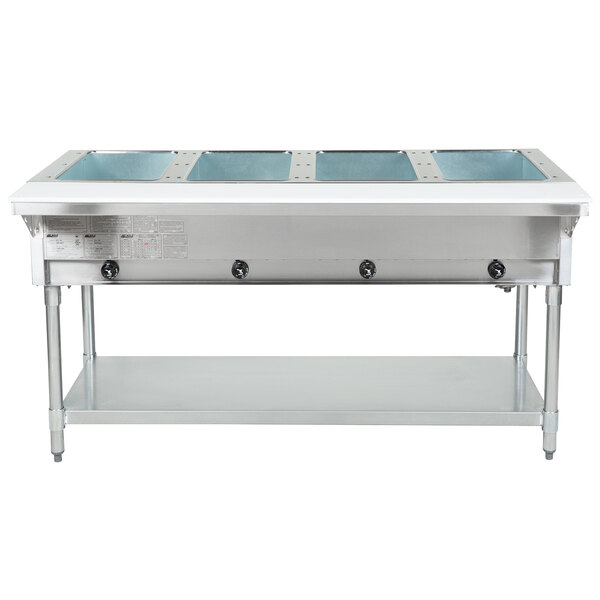 An Eagle Group stainless steel open well hot food table with four pans on a counter.