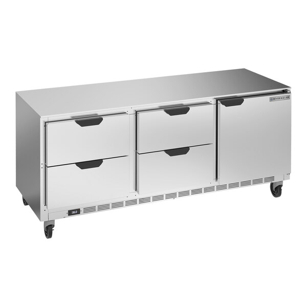 A silver stainless steel undercounter refrigerator with drawers.