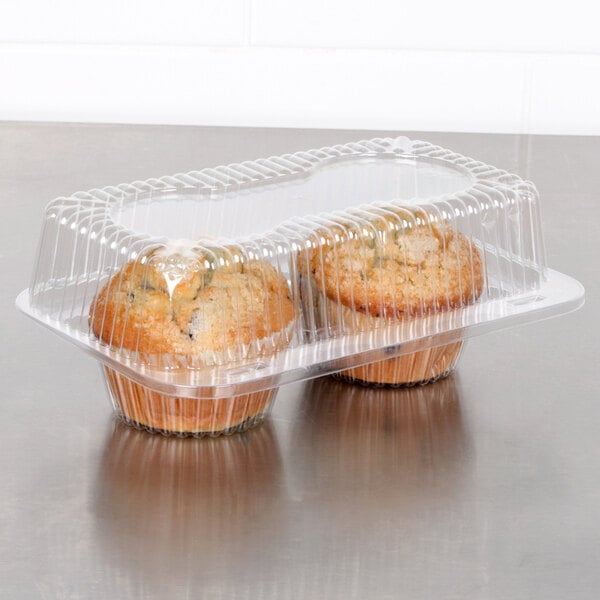 A Polar Pak plastic container with two muffins inside.