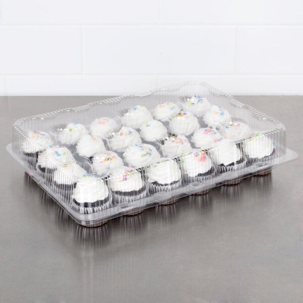 A Polar Pak clear plastic container filled with cupcakes with white frosting and colorful beads.