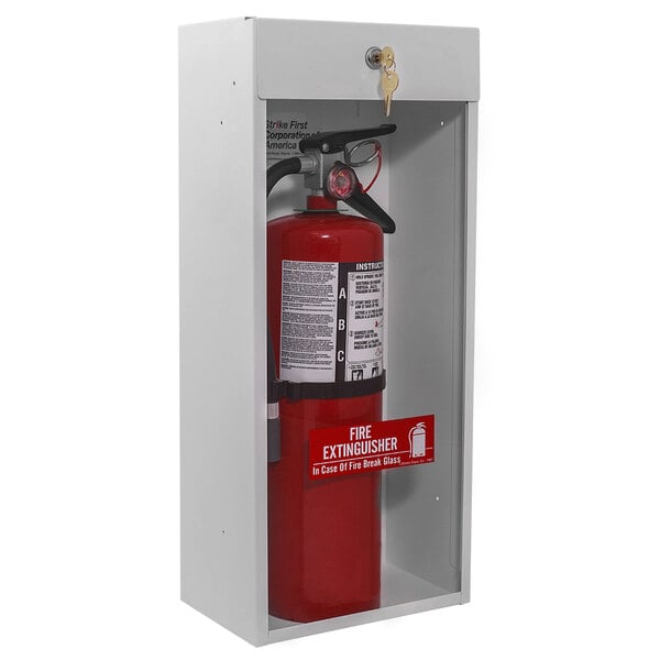 A Strike First fire extinguisher cabinet holding a red and black fire extinguisher.