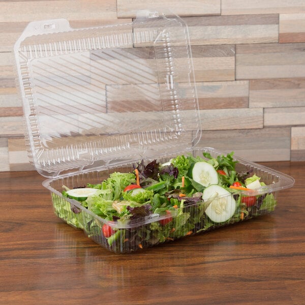A salad in a Polar Pak clear hinged plastic takeout container.