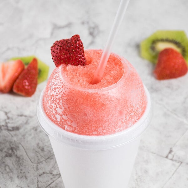 A clear PET dome lid with a straw hole on a cup of strawberry slushy with a straw.