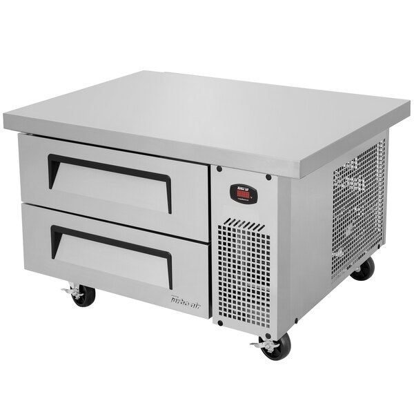A stainless steel Turbo Air chef base with two drawers on wheels.