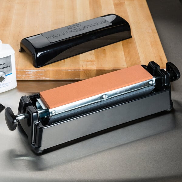 A Victorinox Multi-Oilstone Honing System on a wooden counter.