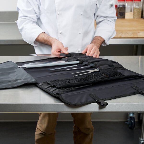 A chef putting a Victorinox knife in a black case.