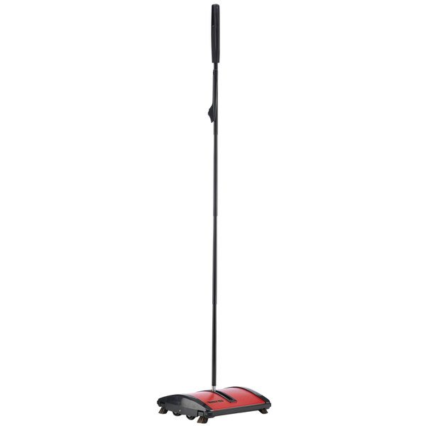 A red and black Oreck Hoky floor sweeper with a black pole.