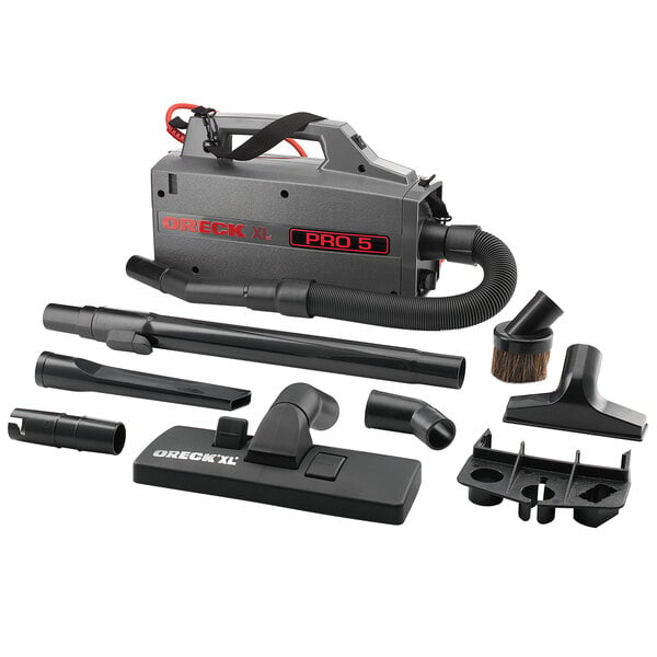 An Oreck black and grey canister vacuum cleaner with various accessories and tools.