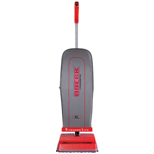 A grey and red Oreck Upright Bagged Vacuum cleaner with a red handle.