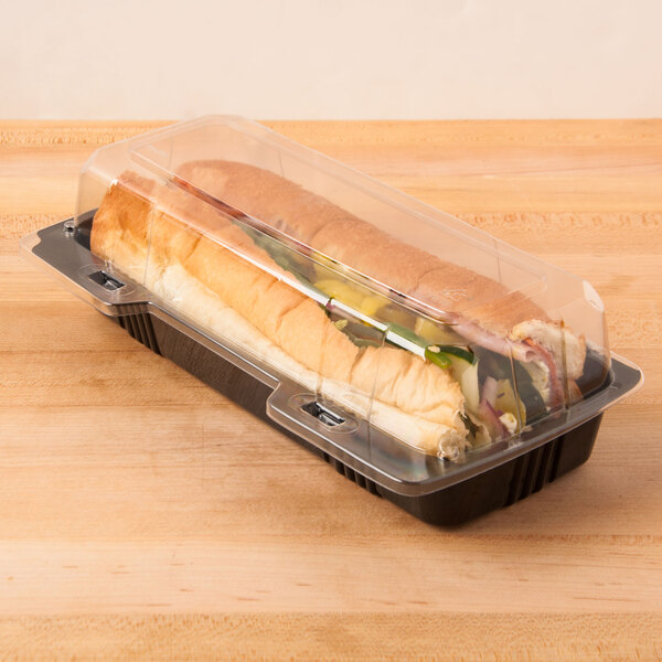 A Polar Pak clear plastic hinged hoagie container with a sandwich inside.