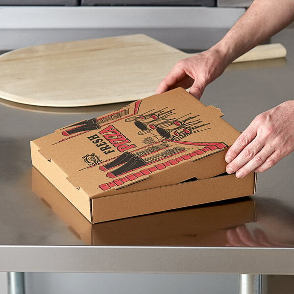 A person holding a Choice Kraft corrugated pizza box.