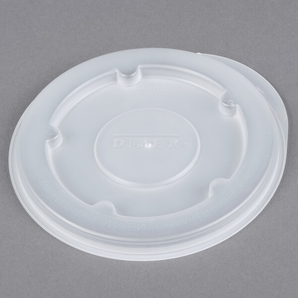 A white plastic lid with a hole.