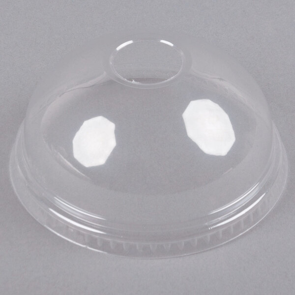 A clear plastic lid with a hole in the middle.