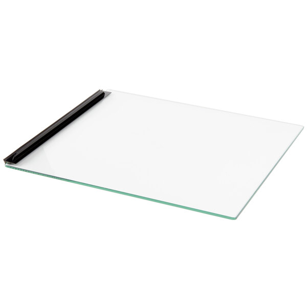 A glass board with a black handle.