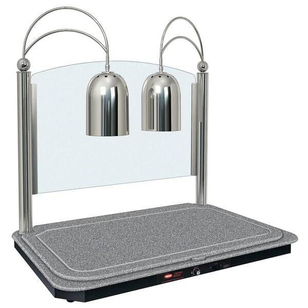 A Hatco dual lamp carving station with a grey granite heated base and silver bell-shaped lamps on a grey surface.