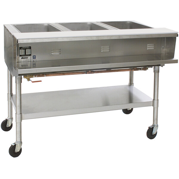 A stainless steel Eagle Group commercial steam table with four pans on a counter.