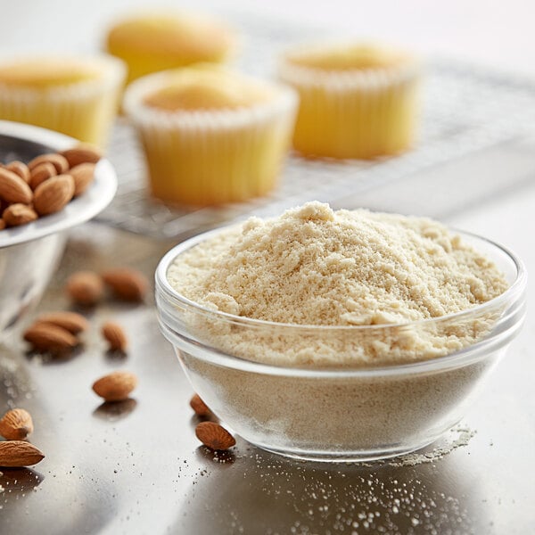 A bowl of almond flour with a cupcake on top.