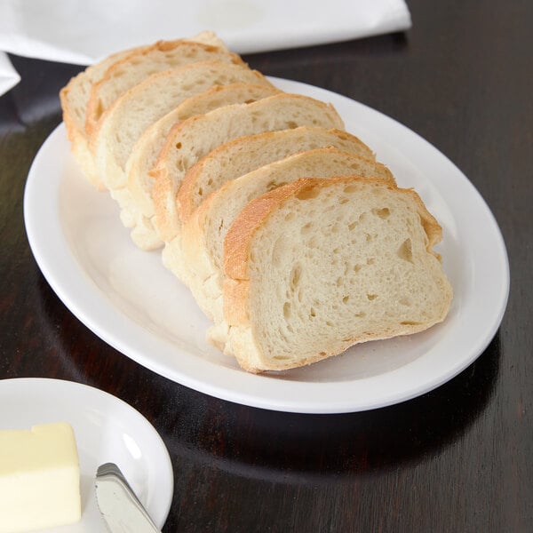 A white Carlisle oval platter with sliced bread on it.