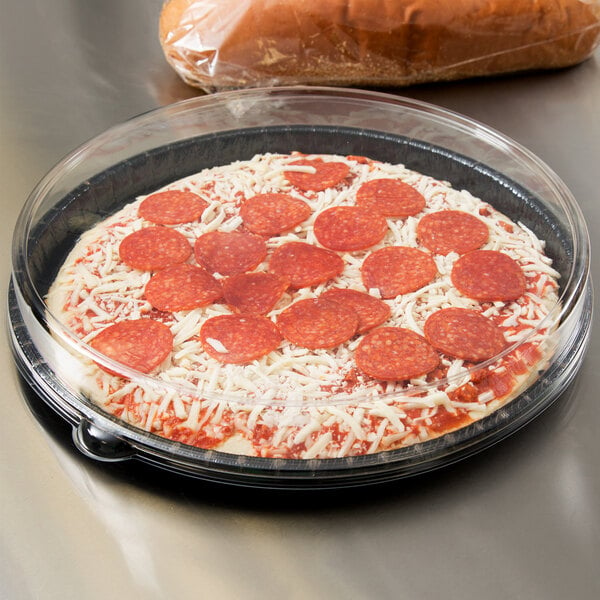 A Solut bake and show pizza tray with a pizza in it.