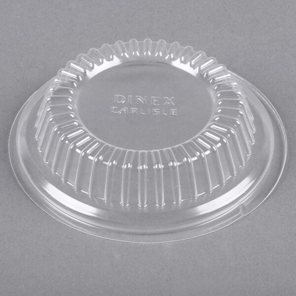 A clear plastic lid with a circular design.