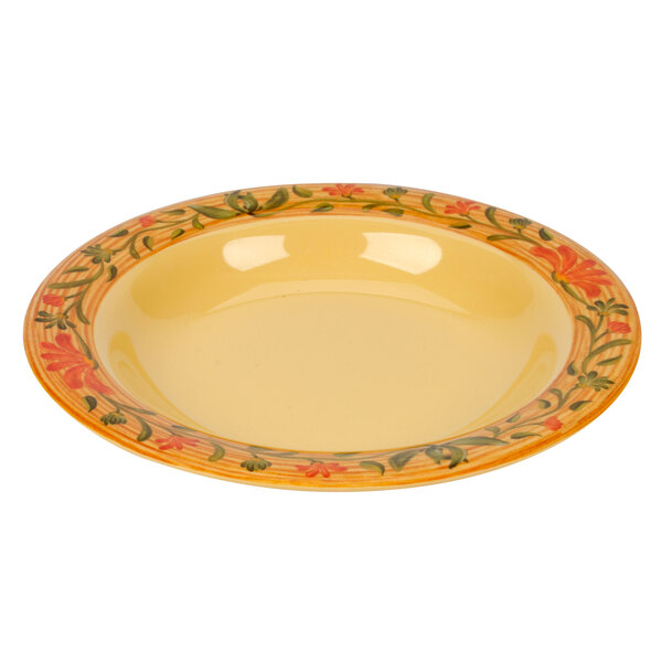 A yellow Venetian melamine bowl with orange and green floral design.