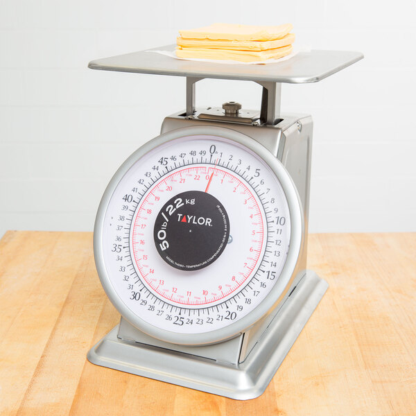 A Taylor heavy duty mechanical portion scale on a counter.