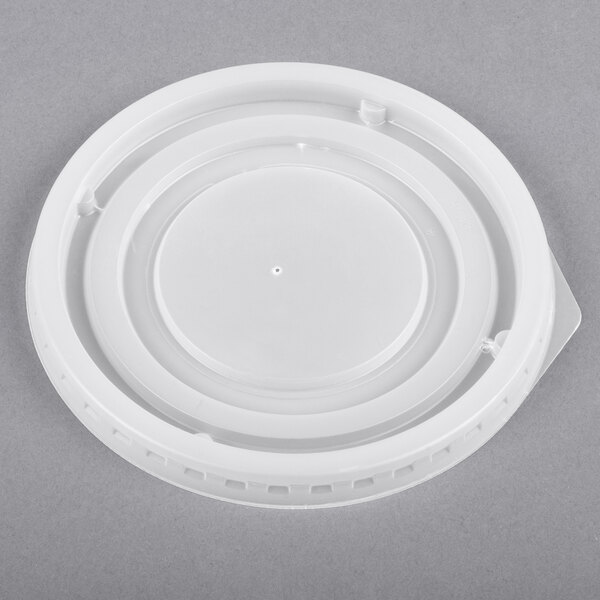 A white plastic lid with a round top and a circular rim.