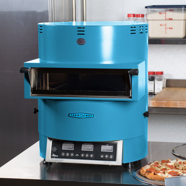 A blue TurboChef Fire countertop pizza oven with a pizza inside.