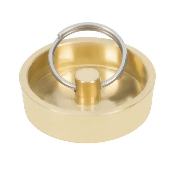 A round gold brass drain plug with a metal ring.