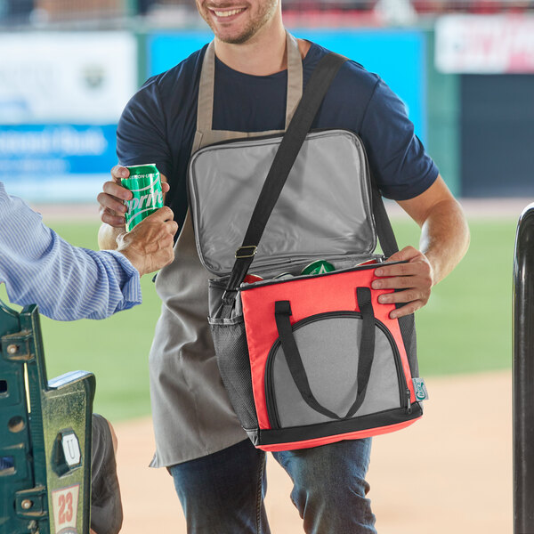 A man holding a Choice red insulated soft cooler bag.