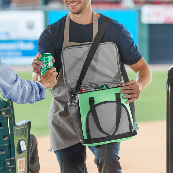 A man in an apron holding a Choice green insulated cooler bag.