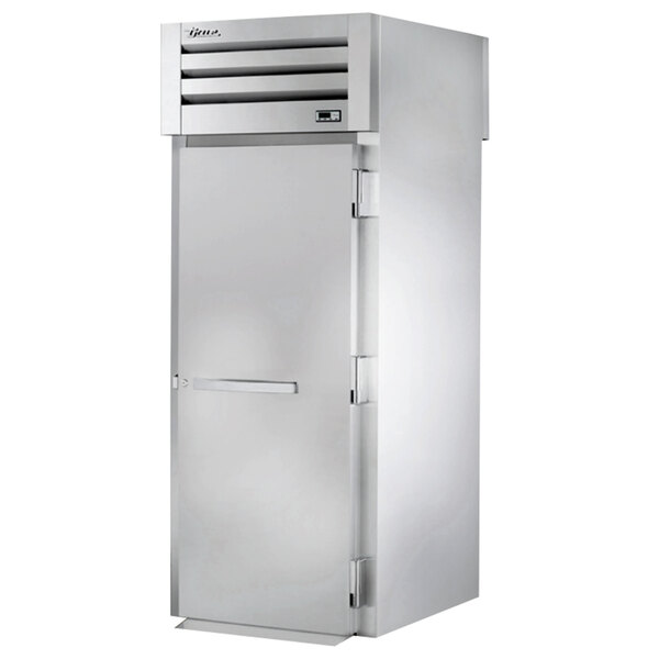 A stainless steel True roll-through refrigerator with a door open.